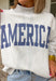 This grey reversible pullover is the ultimate cozy-meets-festive piece for your summer celebrations! Designed with two looks in one, one side features “USA” in navy with a flag design, while the other side is fleece lined with “America” in blue for a softer, cozier feel. The mock neck adds an elevated touch, making it perfect for those cooler summer nights—think fireworks, lake evenings, or early morning coffee runs. It’s an easy throw-on layer that still feels fun and patriotic. 