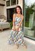 Romantic and effortlessly graceful, this cream strapless midi dress by Entro is made for special warm weather moments. Featuring a beautiful floral print with strawberries throughout, it’s designed with pleated detailing along the chest for a flattering shape and a smocked back for added comfort and flexibility. Side pockets add a practical touch, while the fully lined cotton fabric keeps it light and breathable. This will quickly become a favorite!