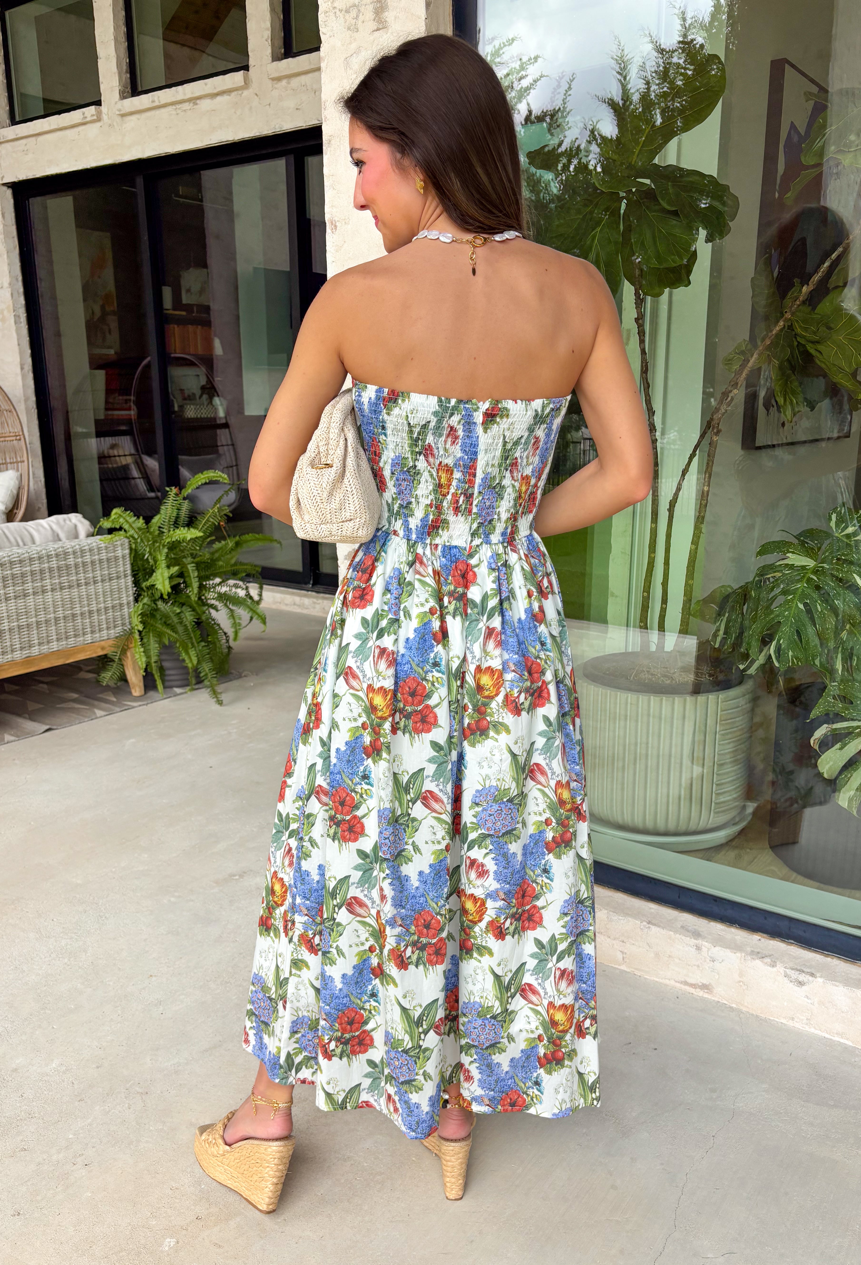 Romantic and effortlessly graceful, this cream strapless midi dress by Entro is made for special warm weather moments. Featuring a beautiful floral print with strawberries throughout, it’s designed with pleated detailing along the chest for a flattering shape and a smocked back for added comfort and flexibility. Side pockets add a practical touch, while the fully lined cotton fabric keeps it light and breathable. This will quickly become a favorite!