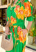 This green midi dress is a total spring showstopper thanks to its bold floral print in sunny orange and yellow! The vibrant blooms pop beautifully against the fresh green background, giving you that cheerful, can’t-miss-it kind of look (in the best way). The flattering v-neckline and matching self-tie waist create an easy, defined shape, while the elastic cuffs keep the sleeves comfy and effortless. Finished with side pockets and a full lining, this dress is ready for everything from brunch to spring events