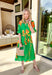 This green midi dress is a total spring showstopper thanks to its bold floral print in sunny orange and yellow! The vibrant blooms pop beautifully against the fresh green background, giving you that cheerful, can’t-miss-it kind of look (in the best way). The flattering v-neckline and matching self-tie waist create an easy, defined shape, while the elastic cuffs keep the sleeves comfy and effortless. Finished with side pockets and a full lining, this dress is ready for everything from brunch to spring events