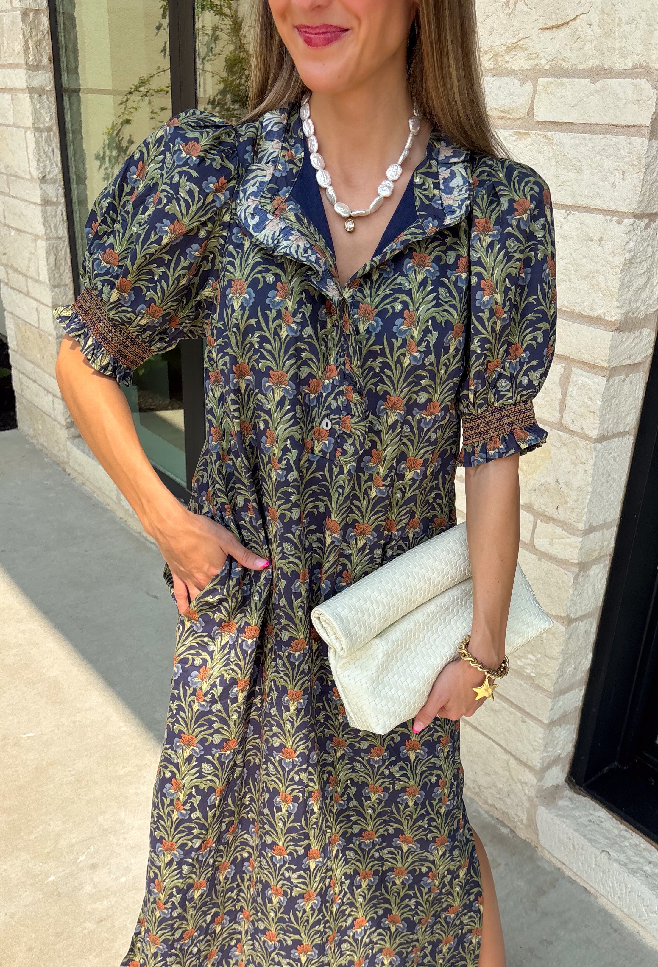 From weekend brunches to family gatherings, this floral midi dress is one you'll be reaching for all season long. Designed in a soft ecru hue with a beautiful floral print, this feminine silhouette is elevated with delicate eyelet lace embroidery throughout for an extra touch of texture and charm. The ruffle neckline, puff sleeves, and tiered ruffle hem create a timeless look, while side pockets make it as practical as it is pretty. 