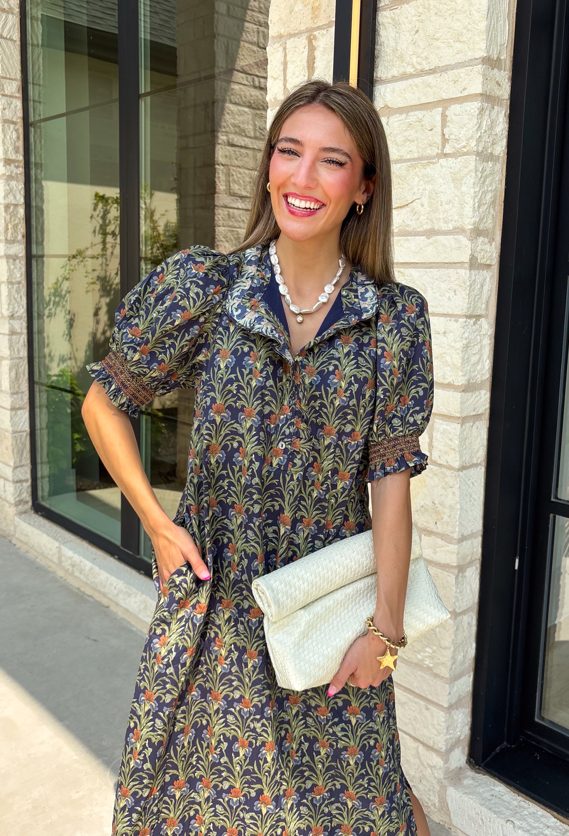 From weekend brunches to family gatherings, this floral midi dress is one you'll be reaching for all season long. Designed in a soft ecru hue with a beautiful floral print, this feminine silhouette is elevated with delicate eyelet lace embroidery throughout for an extra touch of texture and charm. The ruffle neckline, puff sleeves, and tiered ruffle hem create a timeless look, while side pockets make it as practical as it is pretty. 