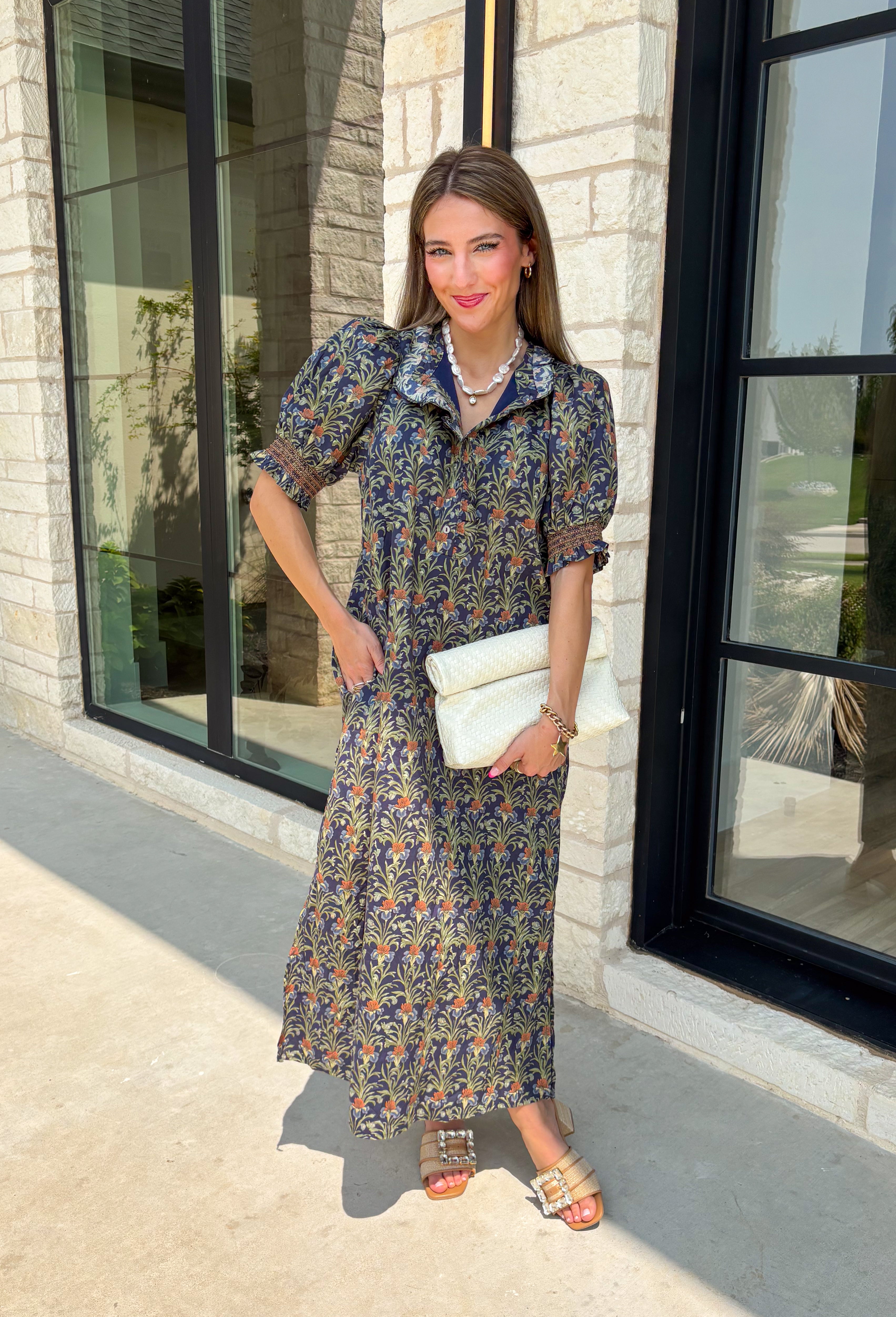 From weekend brunches to family gatherings, this floral midi dress is one you'll be reaching for all season long. Designed in a soft ecru hue with a beautiful floral print, this feminine silhouette is elevated with delicate eyelet lace embroidery throughout for an extra touch of texture and charm. The ruffle neckline, puff sleeves, and tiered ruffle hem create a timeless look, while side pockets make it as practical as it is pretty. 