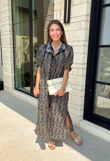 From weekend brunches to family gatherings, this floral midi dress is one you'll be reaching for all season long. Designed in a soft ecru hue with a beautiful floral print, this feminine silhouette is elevated with delicate eyelet lace embroidery throughout for an extra touch of texture and charm. The ruffle neckline, puff sleeves, and tiered ruffle hem create a timeless look, while side pockets make it as practical as it is pretty. 