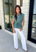 Classic stripes and flattering details make this sleeveless blouse an effortless favorite for fall! Featuring rich hunter green and light blue stripes, and hunter green polka dots, this timeless top is designed with a flattering v-neckline and an adjustable self-tie waist that creates a beautifully defined silhouette. The button front adds a polished finish, while the smocked elastic back offers all-day comfort and the perfect fit. 