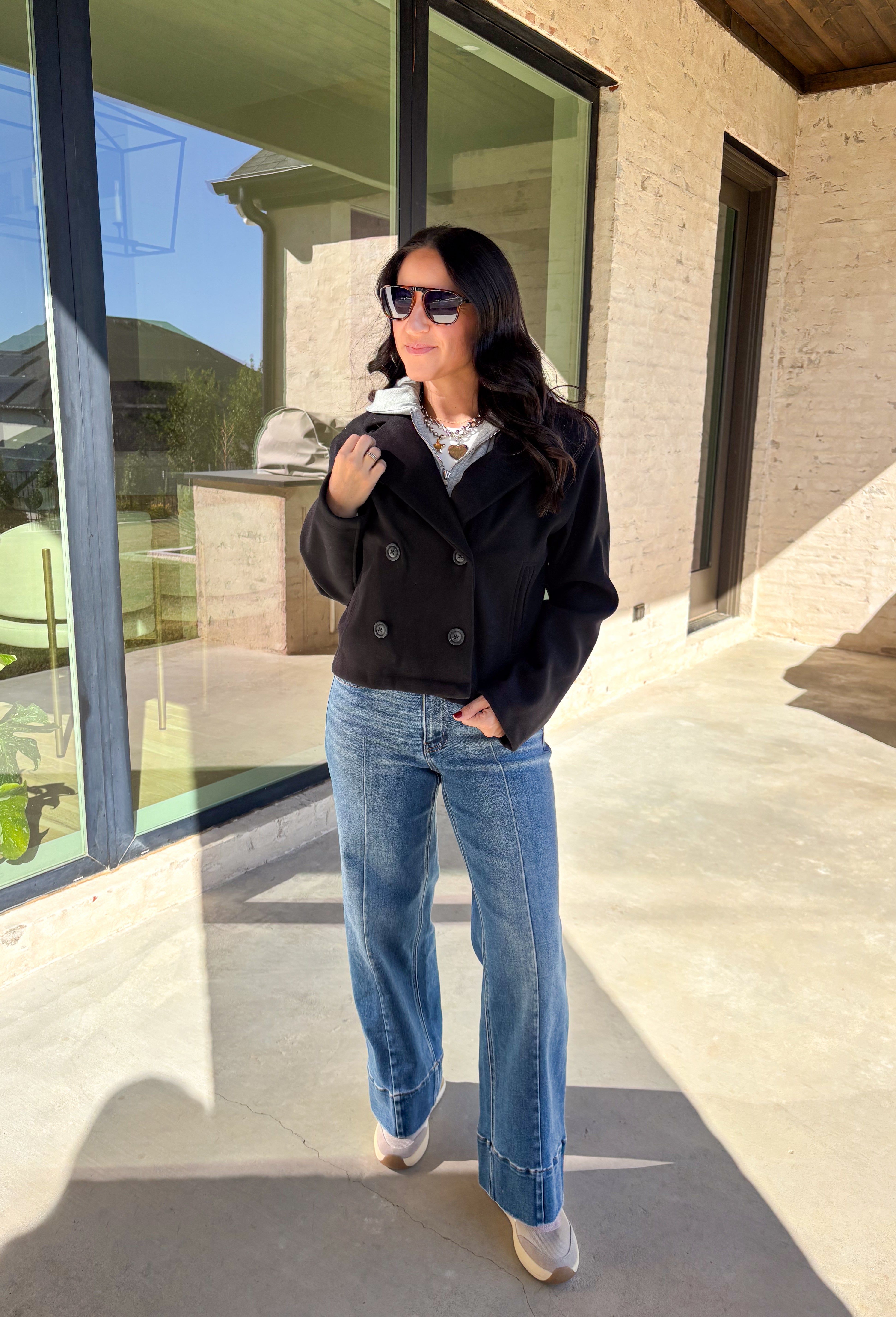 Layered and cozy, this cropped peacoat jacket by Iris brings together the best of both worlds—a timeless wool-inspired peacoat look with a built-in gray hoodie insert for casual comfort. The double-breasted front adds classic structure, while the soft gray hood gives it a relaxed, everyday twist. With side pockets and a cropped length, it’s the perfect piece for adding a cozy, layered touch to your winter outfits.