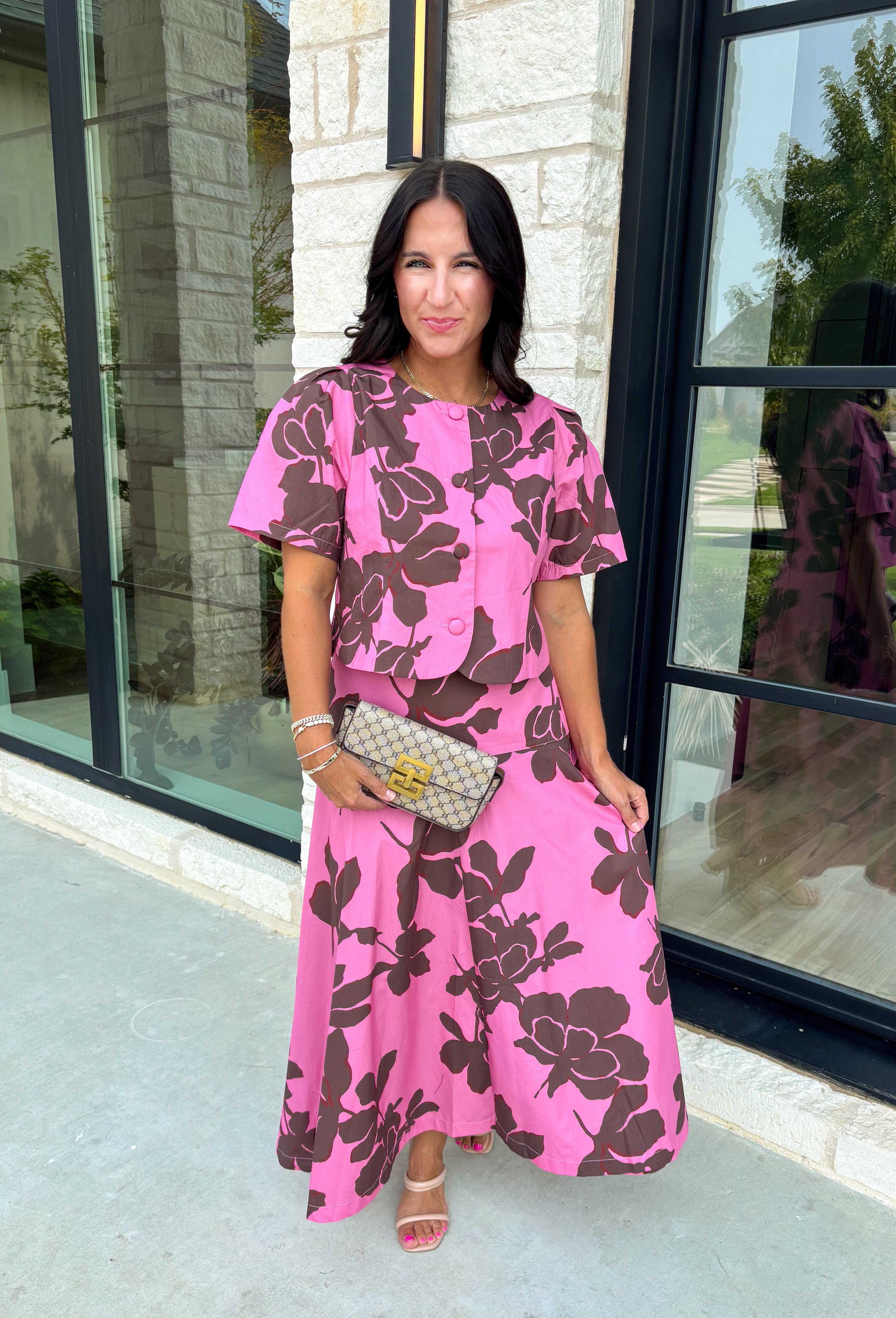 Add a fresh pop of color to your fall wardrobe with this charming floral top that's as versatile as it is pretty! Designed in a beautiful pink hue with a rich brown floral print, this lightweight cotton blouse brings the perfect blend of feminine style and everyday comfort. Wear it with the coordinating skirt for an effortlessly polished matching set, or style it on its own with your favorite denim or trousers for endless outfit possibilities.