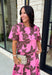 Add a fresh pop of color to your fall wardrobe with this charming floral top that's as versatile as it is pretty! Designed in a beautiful pink hue with a rich brown floral print, this lightweight cotton blouse brings the perfect blend of feminine style and everyday comfort. Wear it with the coordinating skirt for an effortlessly polished matching set, or style it on its own with your favorite denim or trousers for endless outfit possibilities.