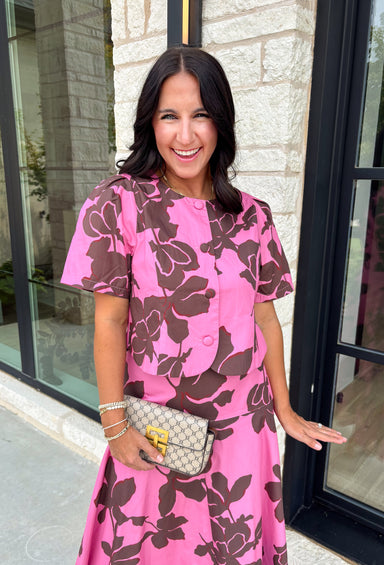 Add a fresh pop of color to your fall wardrobe with this charming floral top that's as versatile as it is pretty! Designed in a beautiful pink hue with a rich brown floral print, this lightweight cotton blouse brings the perfect blend of feminine style and everyday comfort. Wear it with the coordinating skirt for an effortlessly polished matching set, or style it on its own with your favorite denim or trousers for endless outfit possibilities.