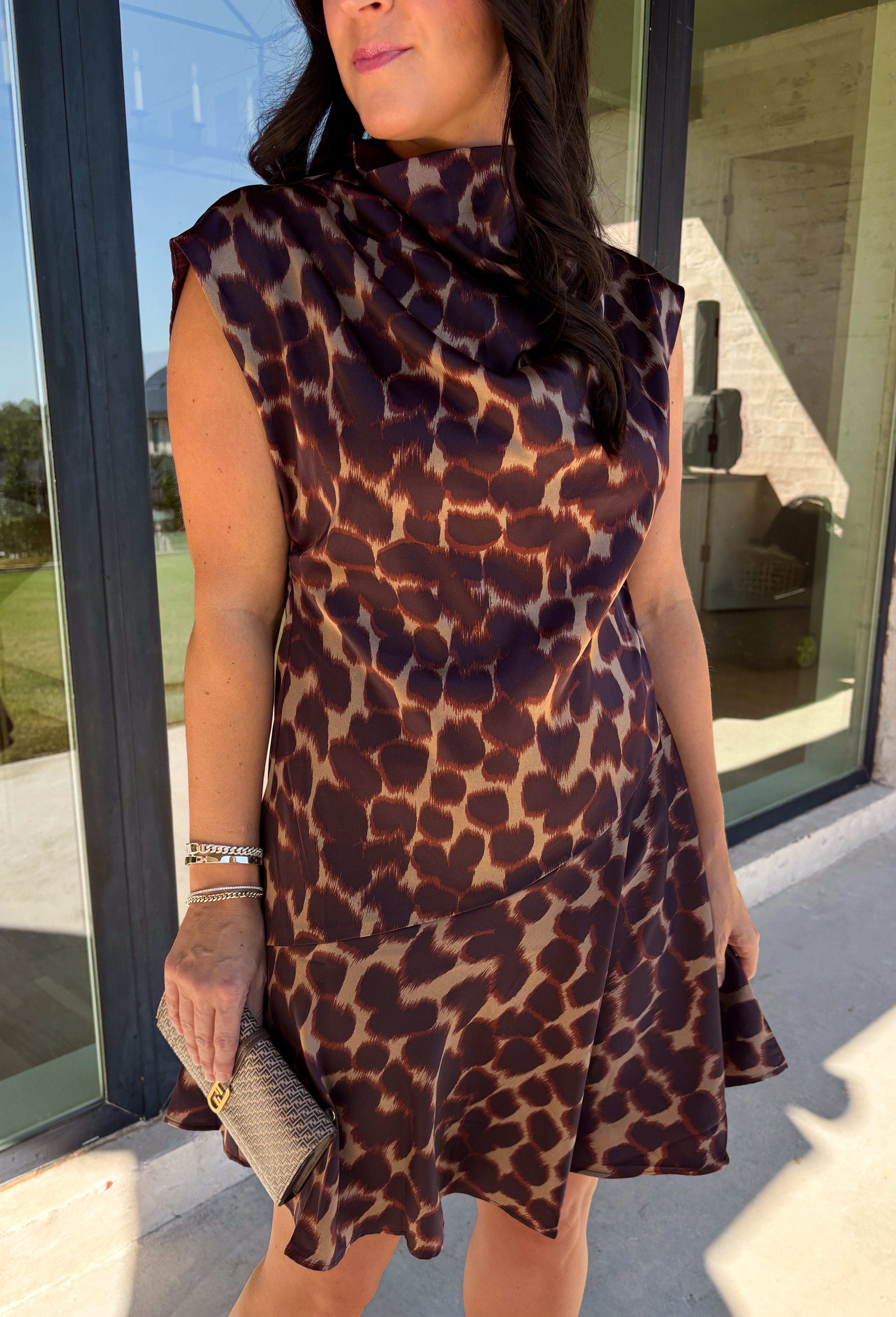 Leopard gets a dressed-up update with this satin dress from THML. The smooth satin fabric gives the classic animal print a little extra shine, making it a fun choice as fall events start giving way to holiday parties and seasonal celebrations. A draped mock neckline creates a flattering focal point, while the short sleeves keep the silhouette simple and easy to accessorize. A keyhole closure at the back adds a pretty finishing detail, and the fully lined design provides comfortable coverage. 