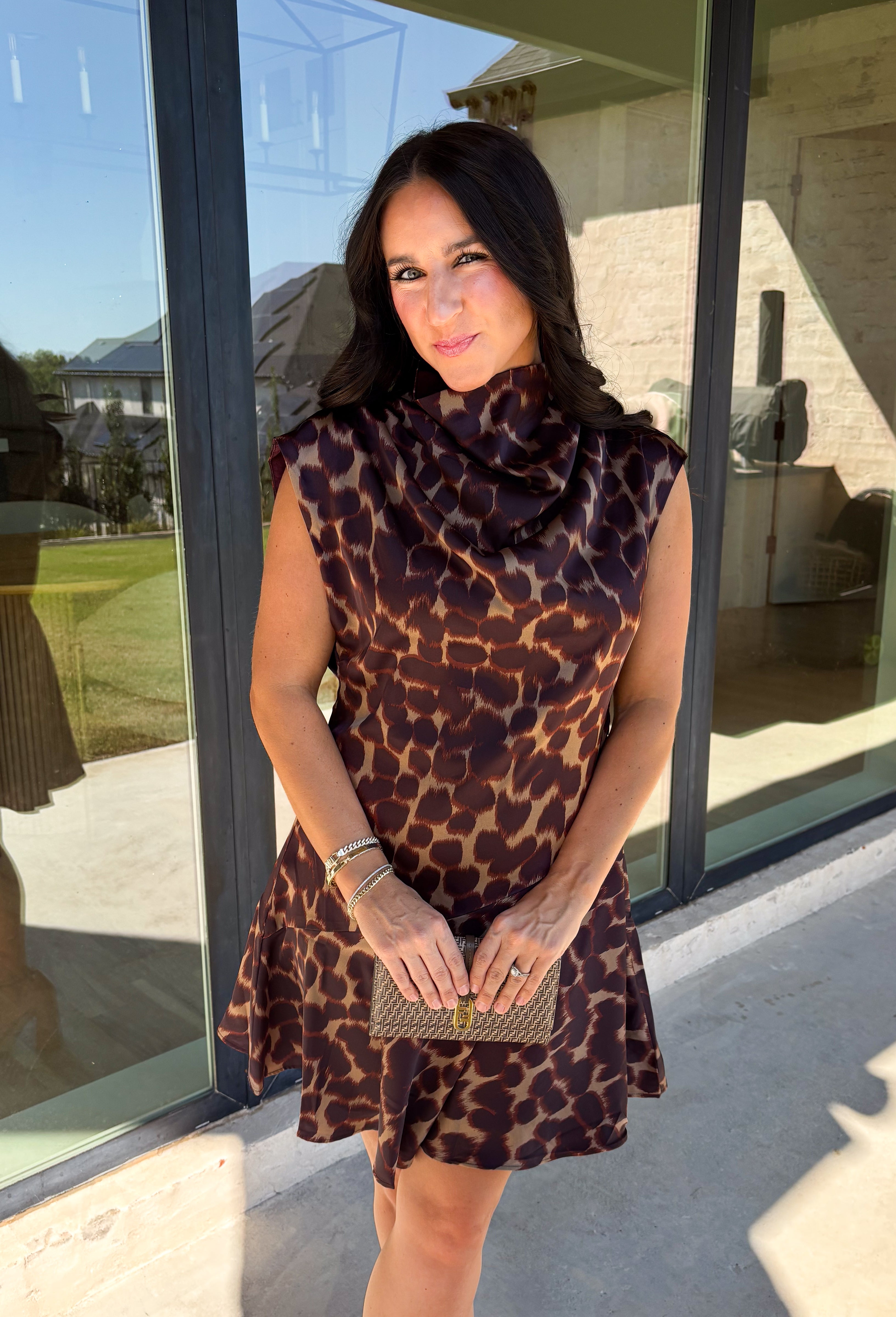 Leopard gets a dressed-up update with this satin dress from THML. The smooth satin fabric gives the classic animal print a little extra shine, making it a fun choice as fall events start giving way to holiday parties and seasonal celebrations. A draped mock neckline creates a flattering focal point, while the short sleeves keep the silhouette simple and easy to accessorize. A keyhole closure at the back adds a pretty finishing detail, and the fully lined design provides comfortable coverage. 