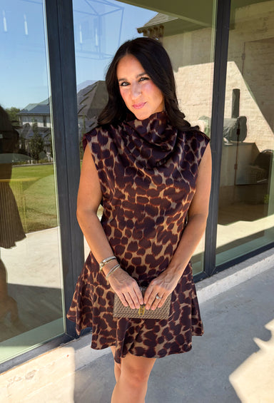 Leopard gets a dressed-up update with this satin dress from THML. The smooth satin fabric gives the classic animal print a little extra shine, making it a fun choice as fall events start giving way to holiday parties and seasonal celebrations. A draped mock neckline creates a flattering focal point, while the short sleeves keep the silhouette simple and easy to accessorize. A keyhole closure at the back adds a pretty finishing detail, and the fully lined design provides comfortable coverage. 