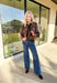 Add a touch of glam to your winter denim collection with these high-waisted wide leg jeans by Risen. Designed in a medium wash with striking black rhinestone detailing along the front, this pair blends everyday comfort with just the right amount of sparkle. The soft stretch denim and flattering wide leg silhouette make them perfect for dressing up or down all season long.
