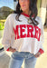 Get into the holiday spirit with this cheerful off-white pullover by Tres Bien! Featuring bold red “Merry” lettering and matching red trim along the neckline, sleeves, and hem, this cozy oversized pullover is pure festive fun. Soft, comfy, and perfect for pairing with your favorite jeans or leggings, it’s made for cookie baking, movie marathons, and all your merry moments this season.