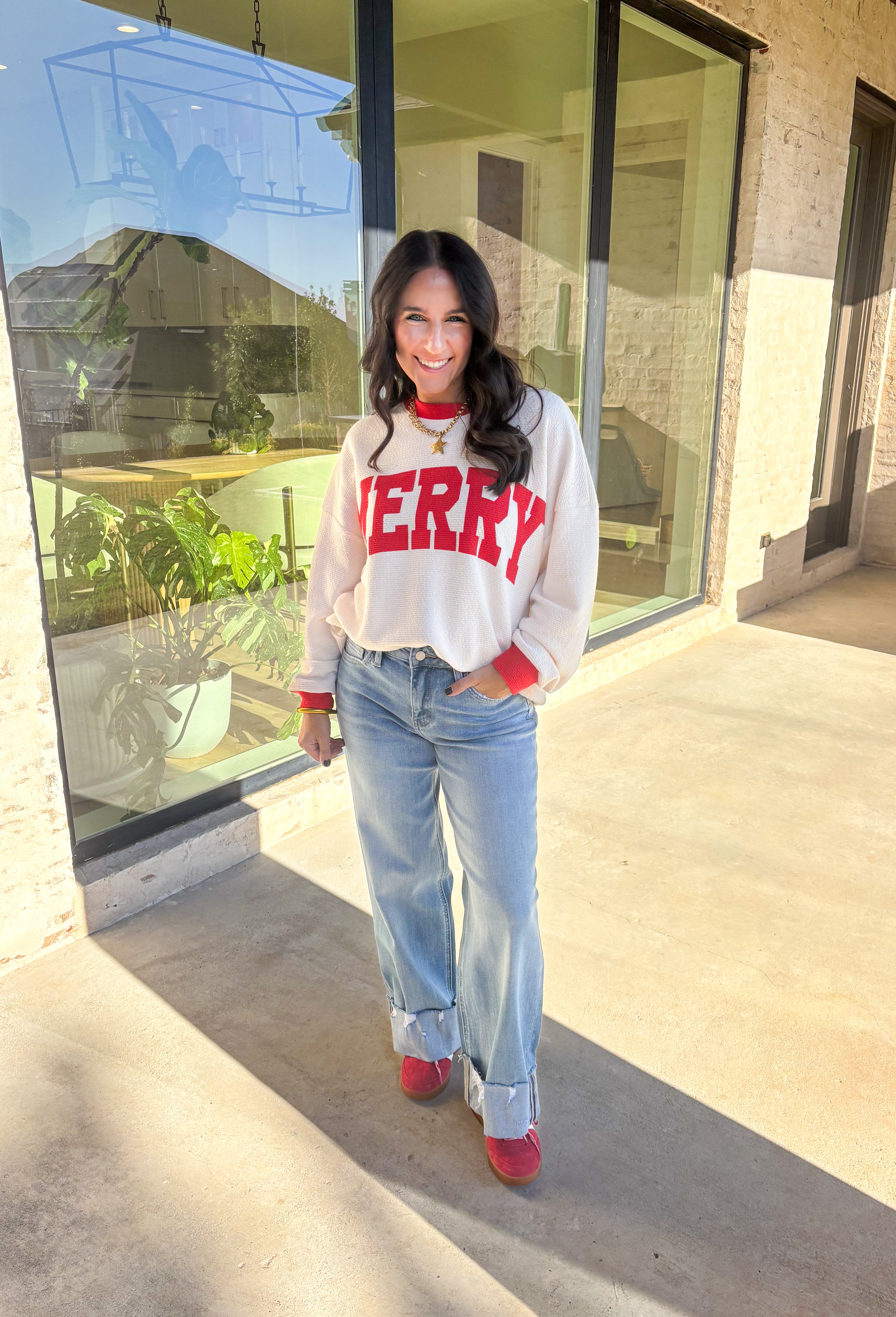 Get into the holiday spirit with this cheerful off-white pullover by Tres Bien! Featuring bold red “Merry” lettering and matching red trim along the neckline, sleeves, and hem, this cozy oversized pullover is pure festive fun. Soft, comfy, and perfect for pairing with your favorite jeans or leggings, it’s made for cookie baking, movie marathons, and all your merry moments this season.