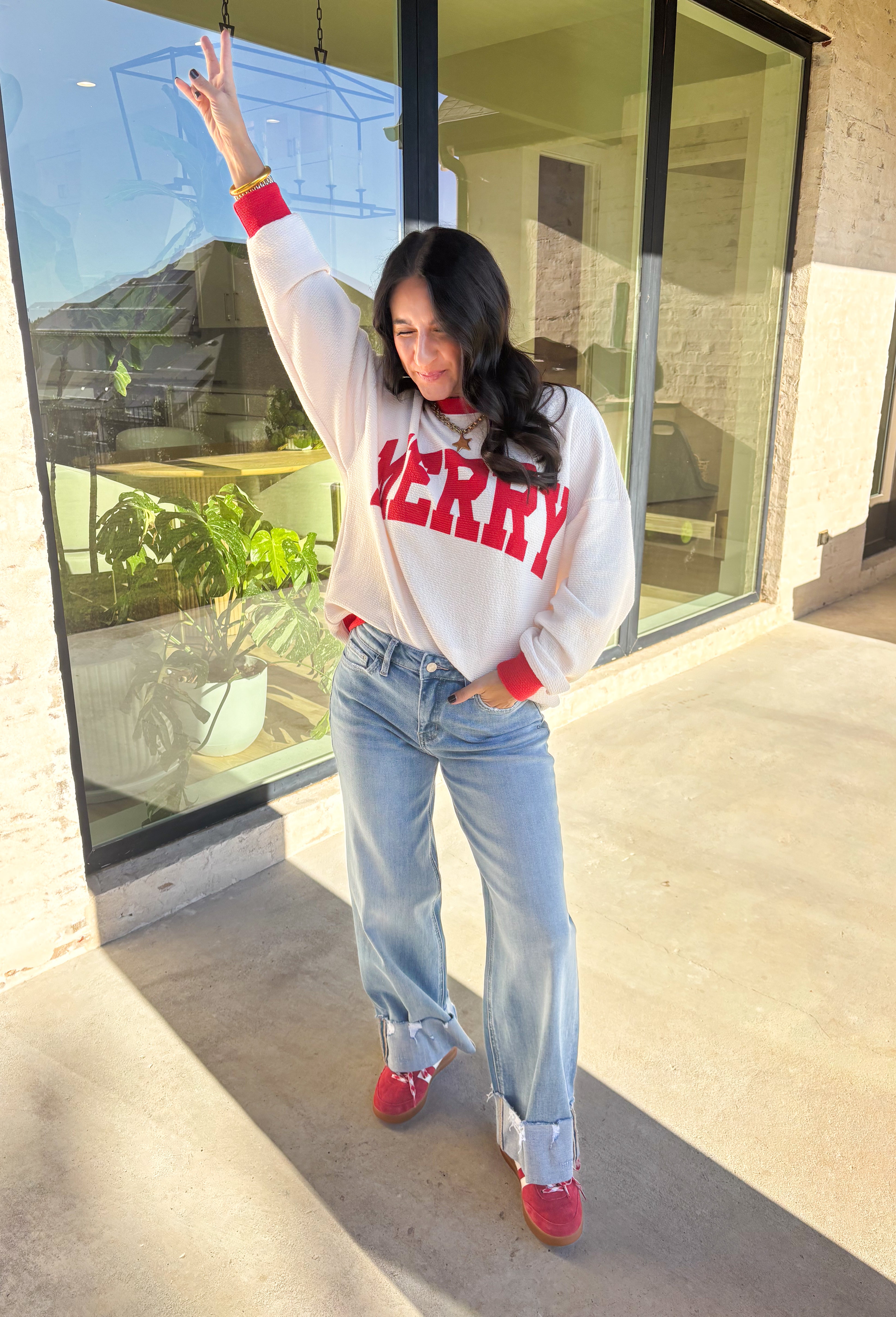 Get into the holiday spirit with this cheerful off-white pullover by Tres Bien! Featuring bold red “Merry” lettering and matching red trim along the neckline, sleeves, and hem, this cozy oversized pullover is pure festive fun. Soft, comfy, and perfect for pairing with your favorite jeans or leggings, it’s made for cookie baking, movie marathons, and all your merry moments this season.