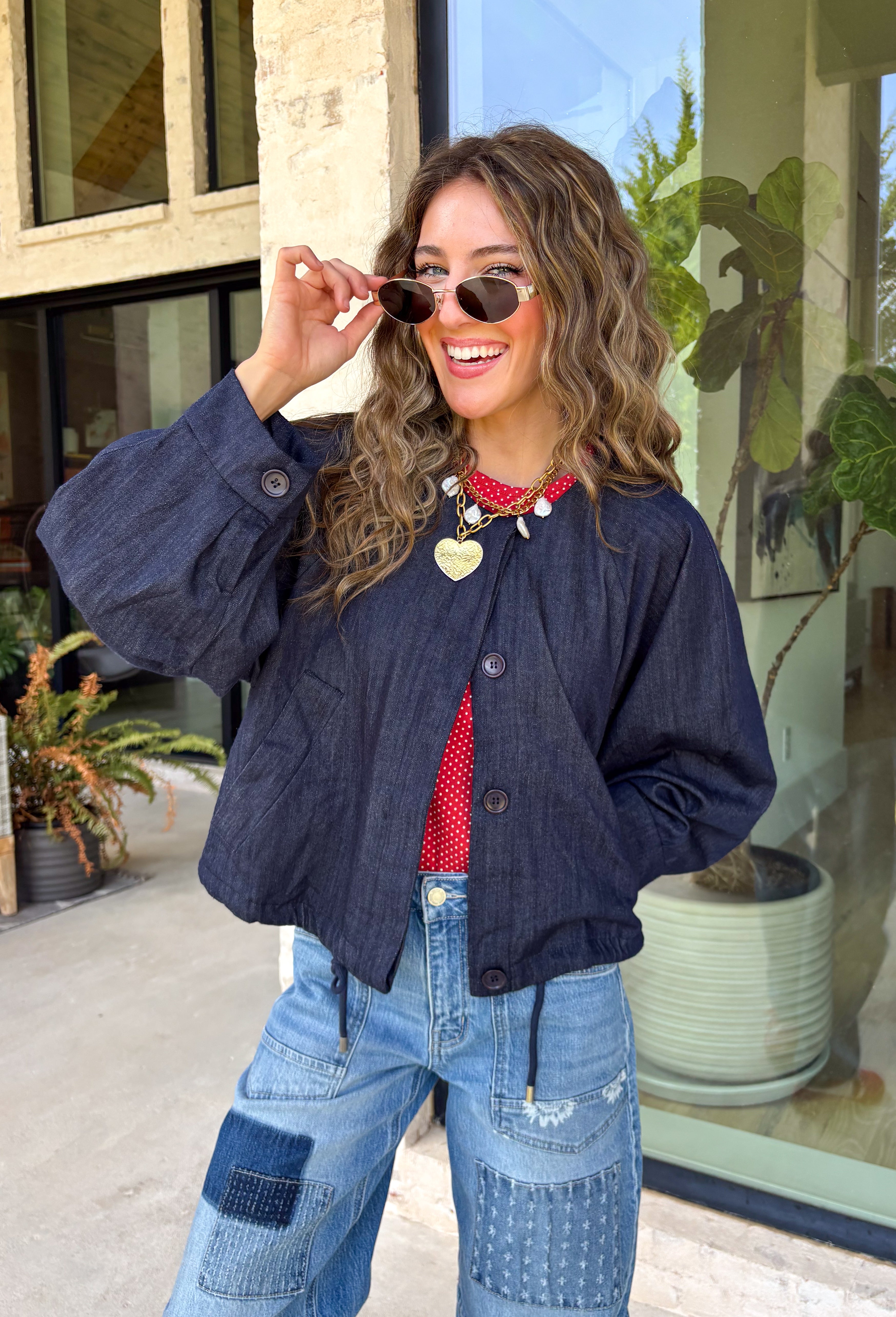 Meet the lightweight jacket you'll be reaching for all season long. Designed in a versatile navy hue, this timeless layering piece combines effortless style with everyday functionality. The button-front design and adjustable drawstring waist create a flattering, customizable fit, while the front pockets add the perfect finishing touch for keeping your essentials close. 