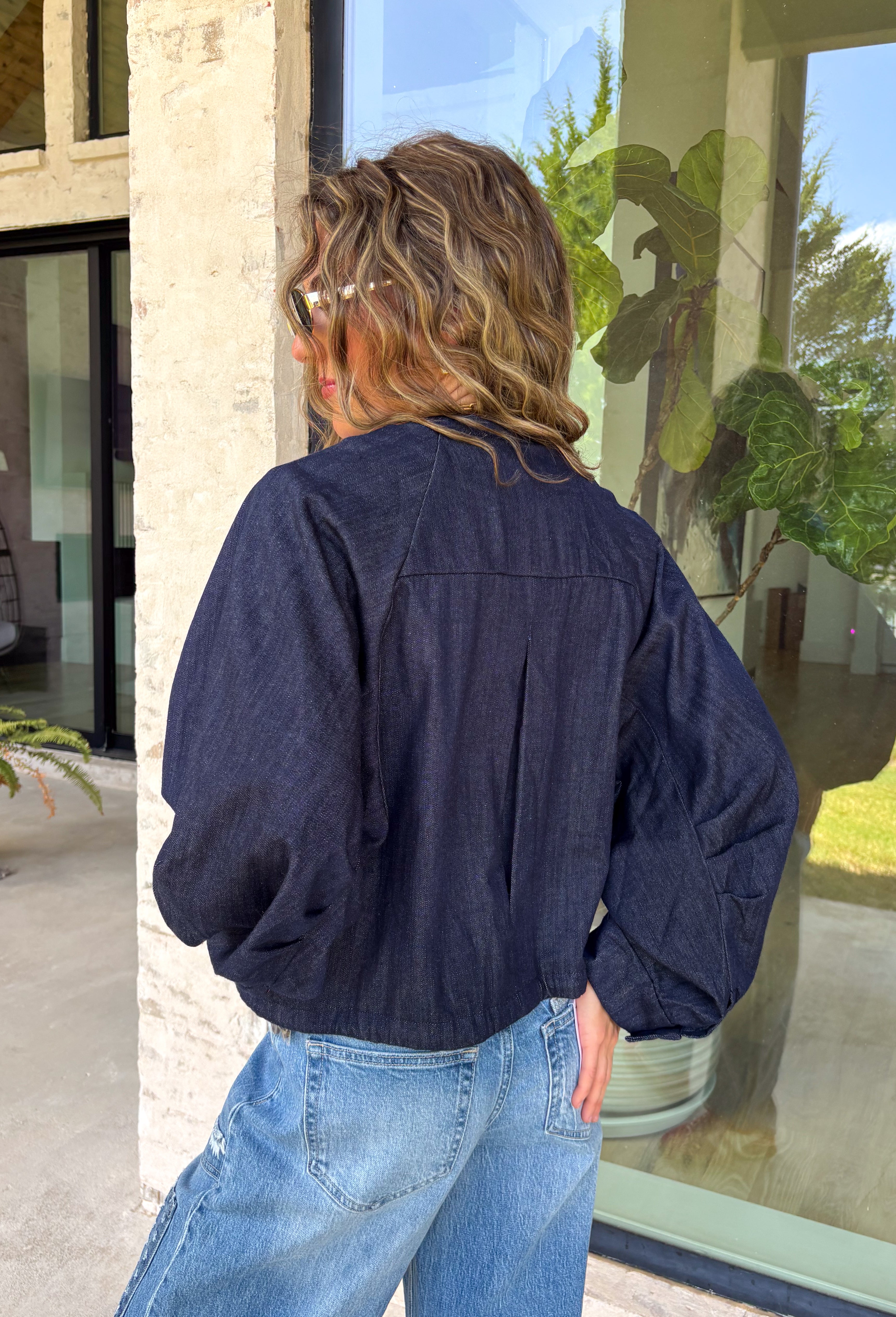 Meet the lightweight jacket you'll be reaching for all season long. Designed in a versatile navy hue, this timeless layering piece combines effortless style with everyday functionality. The button-front design and adjustable drawstring waist create a flattering, customizable fit, while the front pockets add the perfect finishing touch for keeping your essentials close. 