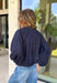 Meet the lightweight jacket you'll be reaching for all season long. Designed in a versatile navy hue, this timeless layering piece combines effortless style with everyday functionality. The button-front design and adjustable drawstring waist create a flattering, customizable fit, while the front pockets add the perfect finishing touch for keeping your essentials close. 