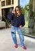 Meet the lightweight jacket you'll be reaching for all season long. Designed in a versatile navy hue, this timeless layering piece combines effortless style with everyday functionality. The button-front design and adjustable drawstring waist create a flattering, customizable fit, while the front pockets add the perfect finishing touch for keeping your essentials close. 