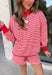 Cozy holiday mornings just found their new uniform with this red and white striped two-piece set from Tres Bien. The oversized long sleeve pullover features a mock neckline with red ribbed trim along the neckline, cuffs, and hem for a festive pop of color. Matching shorts keep the look relaxed and comfortable with an elastic waistband and adjustable drawstring detail. 