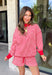 Cozy holiday mornings just found their new uniform with this red and white striped two-piece set from Tres Bien. The oversized long sleeve pullover features a mock neckline with red ribbed trim along the neckline, cuffs, and hem for a festive pop of color. Matching shorts keep the look relaxed and comfortable with an elastic waistband and adjustable drawstring detail. 