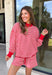 Cozy holiday mornings just found their new uniform with this red and white striped two-piece set from Tres Bien. The oversized long sleeve pullover features a mock neckline with red ribbed trim along the neckline, cuffs, and hem for a festive pop of color. Matching shorts keep the look relaxed and comfortable with an elastic waistband and adjustable drawstring detail. 