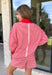 Cozy holiday mornings just found their new uniform with this red and white striped two-piece set from Tres Bien. The oversized long sleeve pullover features a mock neckline with red ribbed trim along the neckline, cuffs, and hem for a festive pop of color. Matching shorts keep the look relaxed and comfortable with an elastic waistband and adjustable drawstring detail. 