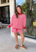 Cozy holiday mornings just found their new uniform with this red and white striped two-piece set from Tres Bien. The oversized long sleeve pullover features a mock neckline with red ribbed trim along the neckline, cuffs, and hem for a festive pop of color. Matching shorts keep the look relaxed and comfortable with an elastic waistband and adjustable drawstring detail. 