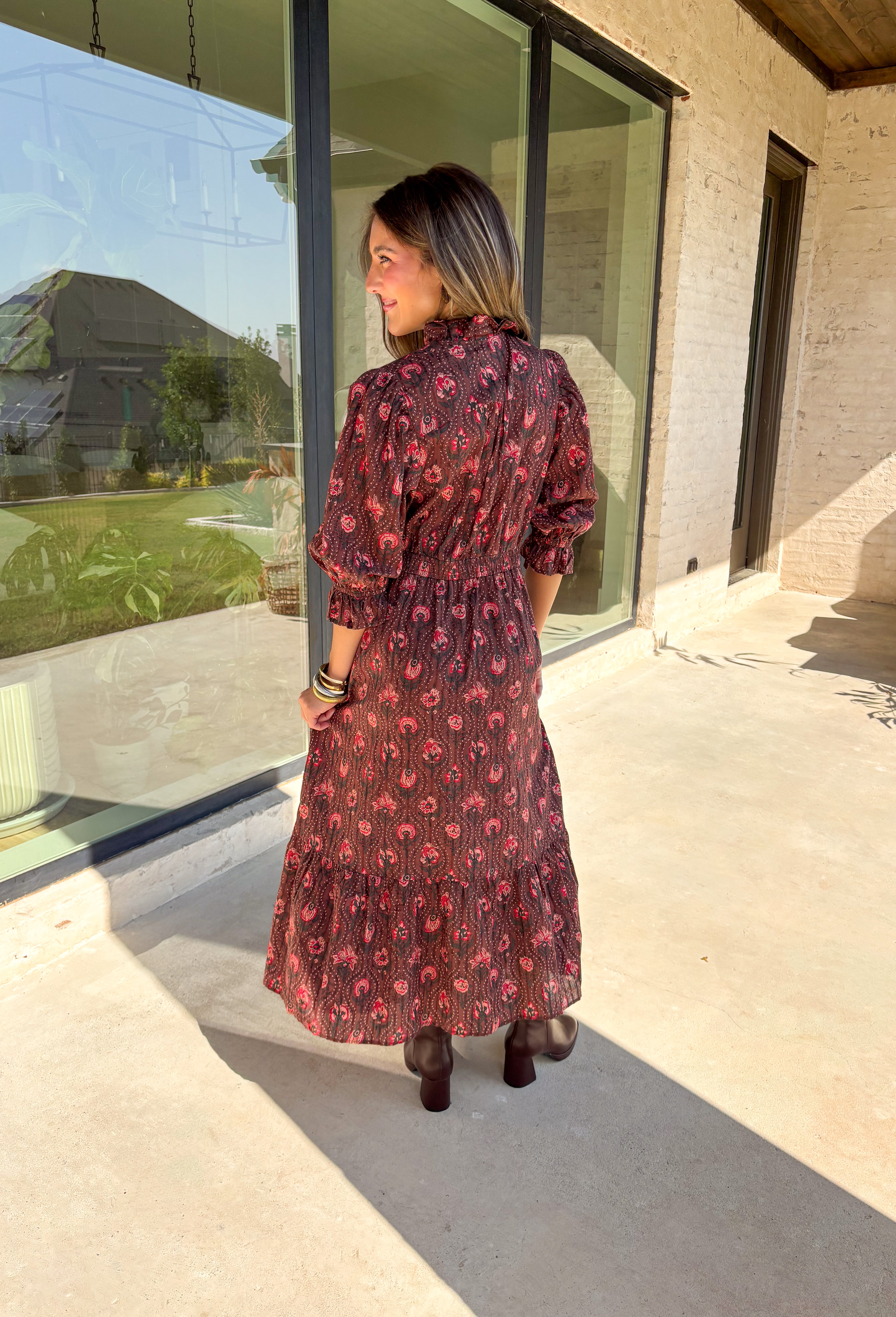 Soft and romantic, this brown midi dress is sprinkled with a neutral floral print accented by pops of red for a seasonal touch. The smocked waist gives it a flattering fit, while the tiered skirt and elastic sleeves keep the silhouette flowy and comfortable. Made from breathable cotton and designed with feminine details, this dress is a versatile piece you can style casually for daytime or dress up for fall gatherings.