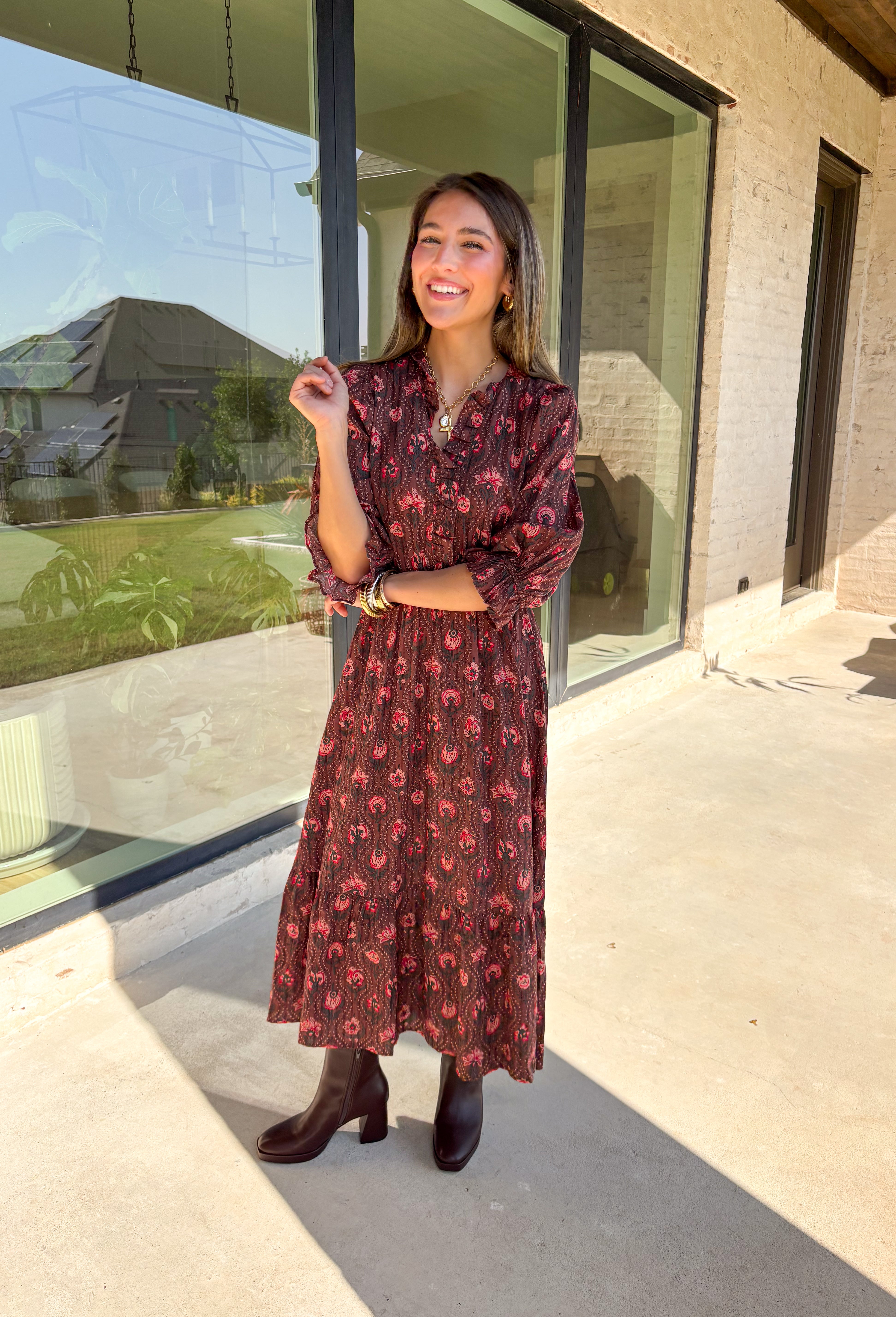 Soft and romantic, this brown midi dress is sprinkled with a neutral floral print accented by pops of red for a seasonal touch. The smocked waist gives it a flattering fit, while the tiered skirt and elastic sleeves keep the silhouette flowy and comfortable. Made from breathable cotton and designed with feminine details, this dress is a versatile piece you can style casually for daytime or dress up for fall gatherings.