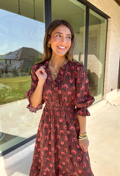 Soft and romantic, this brown midi dress is sprinkled with a neutral floral print accented by pops of red for a seasonal touch. The smocked waist gives it a flattering fit, while the tiered skirt and elastic sleeves keep the silhouette flowy and comfortable. Made from breathable cotton and designed with feminine details, this dress is a versatile piece you can style casually for daytime or dress up for fall gatherings.