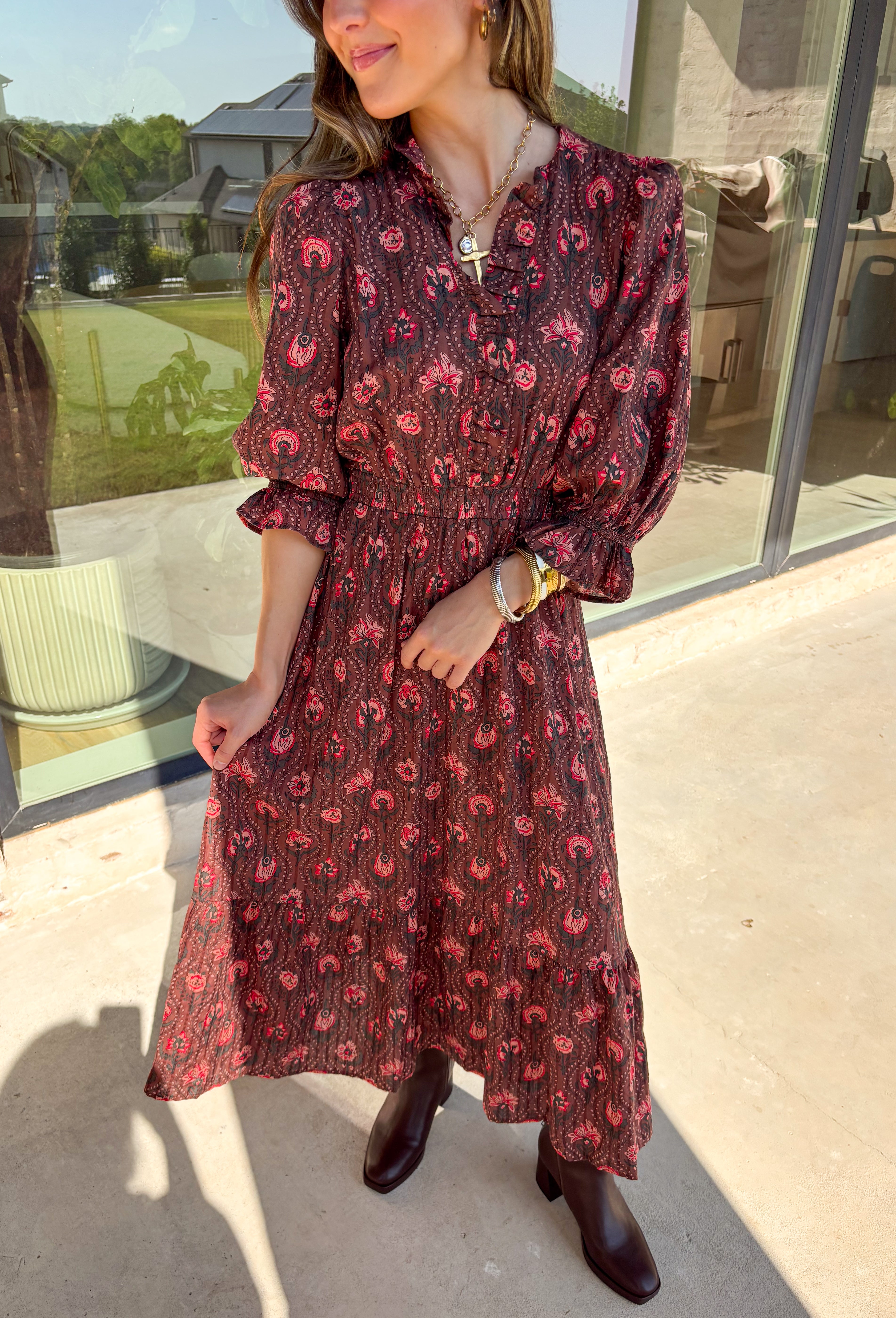 Soft and romantic, this brown midi dress is sprinkled with a neutral floral print accented by pops of red for a seasonal touch. The smocked waist gives it a flattering fit, while the tiered skirt and elastic sleeves keep the silhouette flowy and comfortable. Made from breathable cotton and designed with feminine details, this dress is a versatile piece you can style casually for daytime or dress up for fall gatherings.