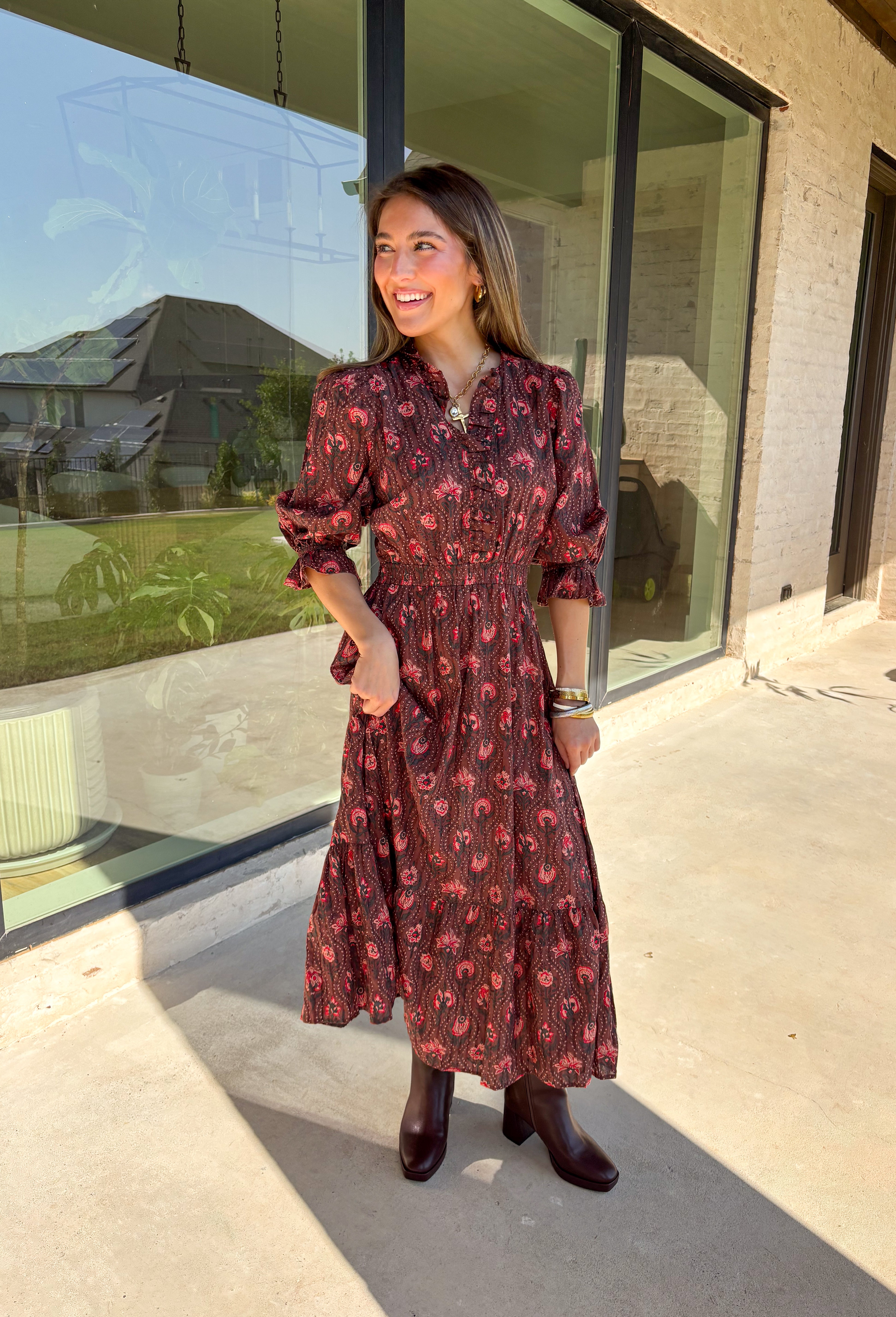 Soft and romantic, this brown midi dress is sprinkled with a neutral floral print accented by pops of red for a seasonal touch. The smocked waist gives it a flattering fit, while the tiered skirt and elastic sleeves keep the silhouette flowy and comfortable. Made from breathable cotton and designed with feminine details, this dress is a versatile piece you can style casually for daytime or dress up for fall gatherings.