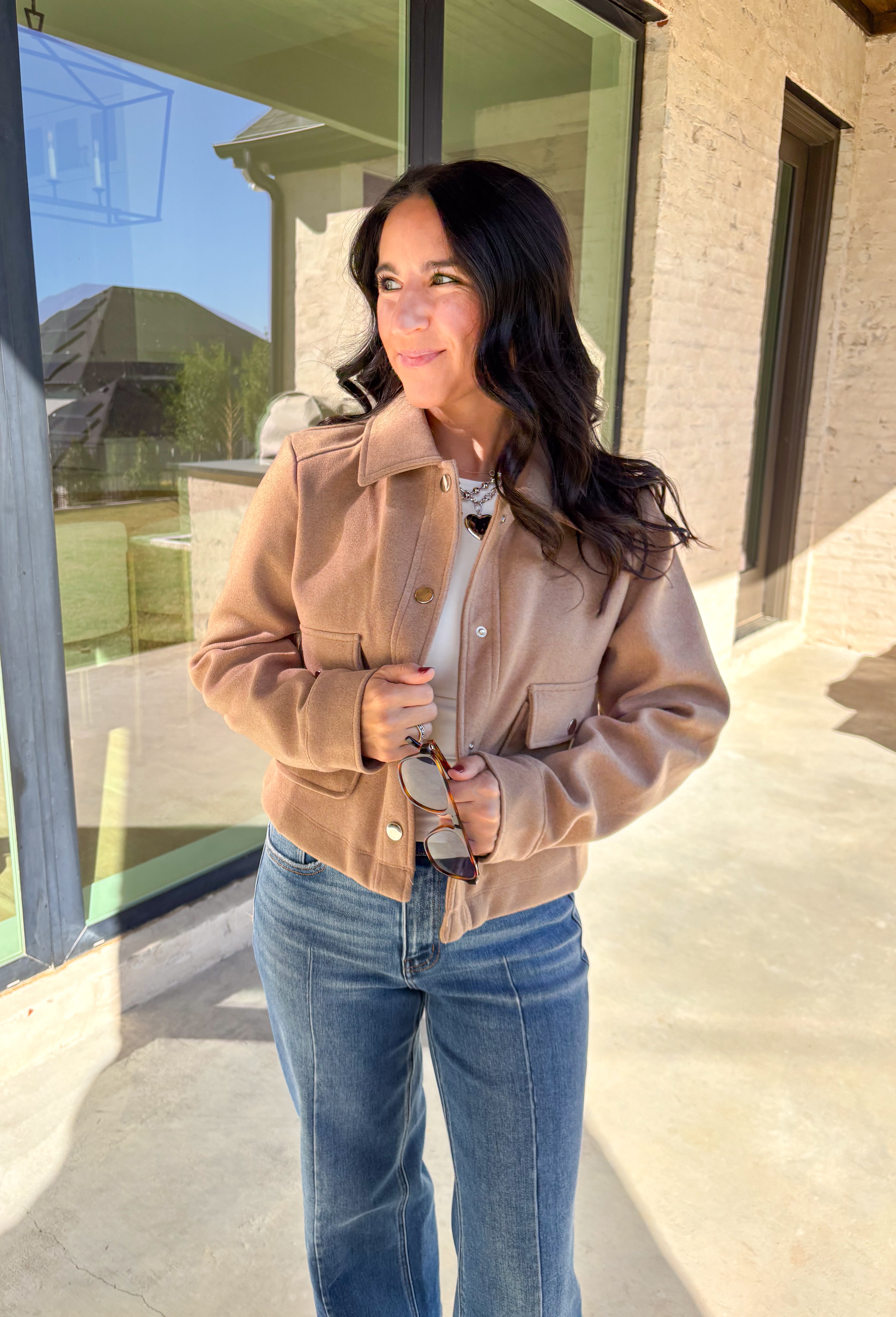 A timeless staple with everyday versatility, this light taupe jacket by Blashe is perfect for layering through the season. Designed with a collared neckline, silver snap button closures, and two front pockets, it balances utility with modern style. Lightweight yet cozy, it’s an easy throw-on piece that works just as well over dresses as it does with denim.