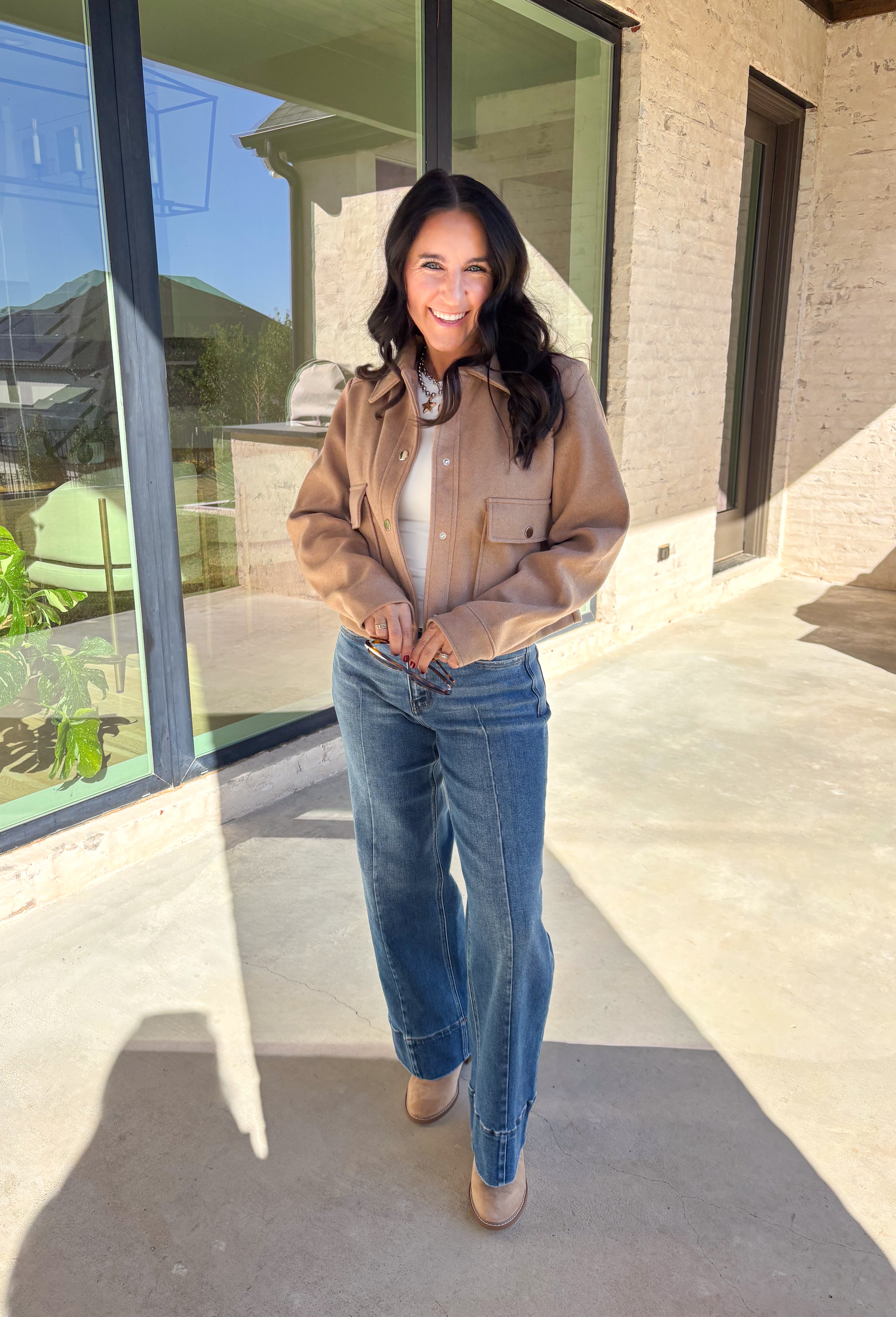 A timeless staple with everyday versatility, this light taupe jacket by Blashe is perfect for layering through the season. Designed with a collared neckline, silver snap button closures, and two front pockets, it balances utility with modern style. Lightweight yet cozy, it’s an easy throw-on piece that works just as well over dresses as it does with denim.