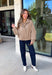 Classic gingham gets a fun fall refresh with this camel and cream jacket from Glam. The neutral checkered print keeps it easy to style, while sequin stitching throughout adds just the right amount of sparkle when it catches the light. A collared neckline and both zipper and button closures give it a structured, jacket-inspired look, while the elastic back hem creates a comfortable shape.