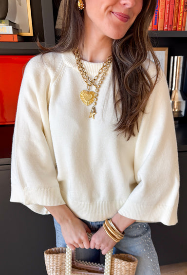 Soft, cozy, and perfect for transitional spring days, this cream sweater knit top by Entro is an easy wardrobe staple. Designed with raglan ¾ length sleeves, it has a relaxed, flattering fit that feels comfortable without being bulky. Ribbed detailing at the neckline, cuffs, and hem adds subtle texture and a polished finish, while the medium-weight knit makes it ideal for cool mornings and breezy afternoons.