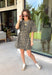 Leopard print is always in style, especially for fall! This olive dress brings together a timeless animal print with an effortlessly flattering silhouette you'll love wearing all season long. The adjustable drawstring waist lets you customize the fit, while the soft fabric keeps it comfortable from morning to night. Finished with short sleeves and everyone's favorite feature—side pockets—this dress is perfect for everything from coffee dates and shopping trips to game days and weekend adventures. 
