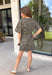Leopard print is always in style, especially for fall! This olive dress brings together a timeless animal print with an effortlessly flattering silhouette you'll love wearing all season long. The adjustable drawstring waist lets you customize the fit, while the soft fabric keeps it comfortable from morning to night. Finished with short sleeves and everyone's favorite feature—side pockets—this dress is perfect for everything from coffee dates and shopping trips to game days and weekend adventures. 