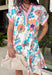 Bright, happy, and made for spring, this off-white short sleeve dress by Entro is bursting with color and charm. Featuring a colorful floral print throughout in shades of coral, blue, pink, and brown, it instantly feels fun and seasonal. The collared neckline adds a classic touch, while the pink and blue trim along the front, neckline, and sleeve cuffs gives it a playful pop of contrast. Fully lined for comfortable wear.
