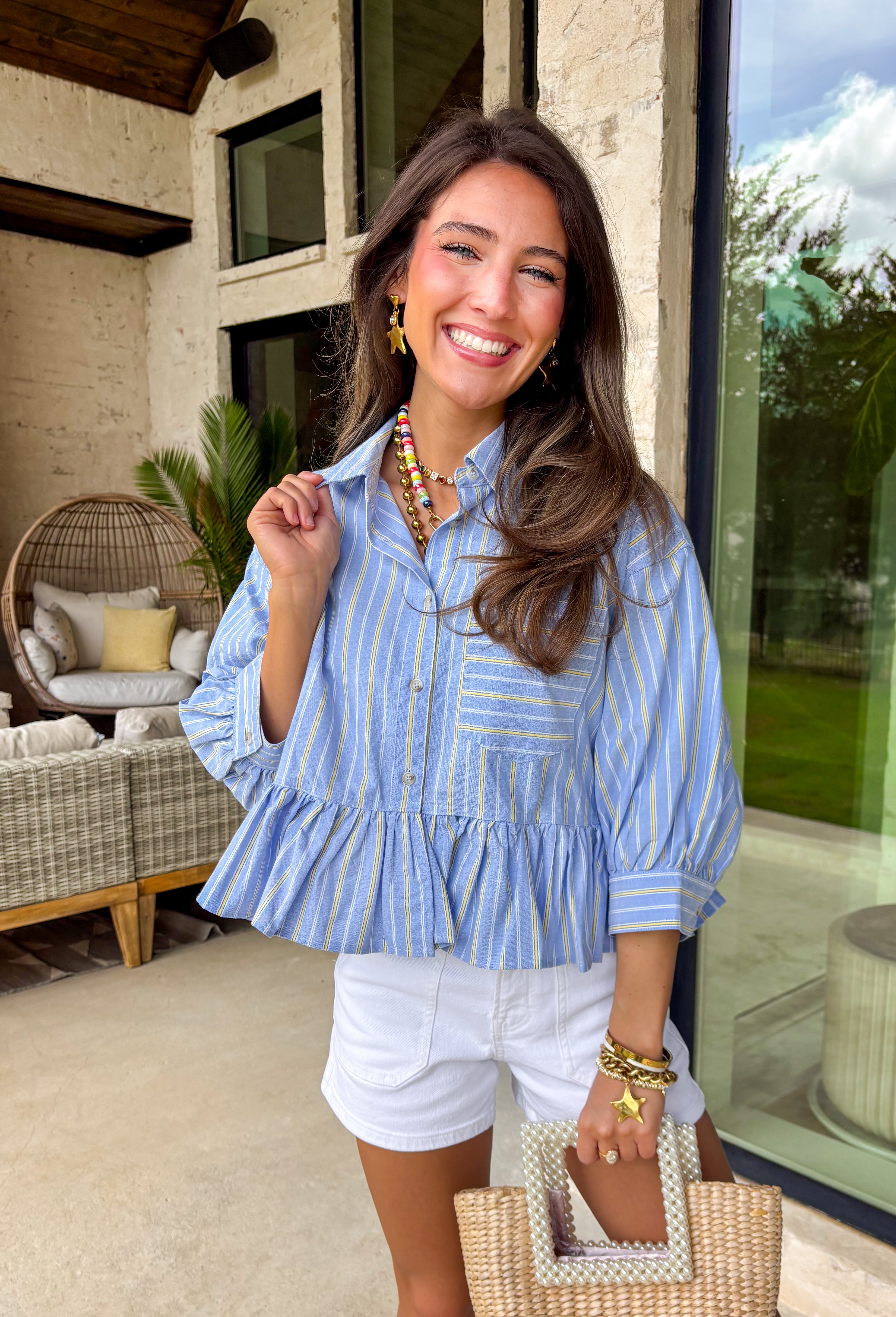 This light blue babydoll top is basically spring in outfit form! With soft pale yellow and white stripes, a classic collared neckline, and a button-down front, it’s the perfect mix of polished and playful. The babydoll silhouette gives you that easy, floaty fit we all love—cute, comfy, and made for sunny days. Finished with a sweet ruffle hem, it’s the kind of top you’ll throw on with denim shorts, white jeans for an effortless, breezy look.