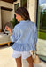 This light blue babydoll top is basically spring in outfit form! With soft pale yellow and white stripes, a classic collared neckline, and a button-down front, it’s the perfect mix of polished and playful. The babydoll silhouette gives you that easy, floaty fit we all love—cute, comfy, and made for sunny days. Finished with a sweet ruffle hem, it’s the kind of top you’ll throw on with denim shorts, white jeans for an effortless, breezy look.