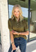 A timeless polka dot print meets feminine details in this effortlessly polished top from Entro. Designed in a rich olive hue with crisp white polka dot accents, this top is perfect for elevating your everyday wardrobe. The ruffled high neckline adds a refined touch, while the button-front closure and contrast cuffs create a beautifully tailored finish. Puff sleeves and button cuffs complete the look, making this versatile blouse an easy choice for everything from workdays to weekend outings.
