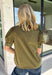 A timeless polka dot print meets feminine details in this effortlessly polished top from Entro. Designed in a rich olive hue with crisp white polka dot accents, this top is perfect for elevating your everyday wardrobe. The ruffled high neckline adds a refined touch, while the button-front closure and contrast cuffs create a beautifully tailored finish. Puff sleeves and button cuffs complete the look, making this versatile blouse an easy choice for everything from workdays to weekend outings.