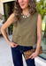 Give your everyday wardrobe a polished update with this effortlessly stylish sleeveless denim top from Entro. Designed in a rich olive denim, this versatile piece features eye-catching gold hardware accent front flap details that add the perfect touch of utility-inspired charm. The clean sleeveless silhouette makes it ideal for layering under jackets and cardigans or wearing on its own.