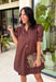 Simple, timeless, and endlessly versatile, this button-front dress is a wardrobe staple you'll reach for all season long. Designed in a rich brown hue, this effortlessly polished dress features a classic button-down front and feminine puff sleeves for the perfect balance of everyday comfort and elevated style. Side pockets add a practical touch, while the breathable cotton fabric keeps it comfortable from morning to night. 
