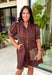 Simple, timeless, and endlessly versatile, this button-front dress is a wardrobe staple you'll reach for all season long. Designed in a rich brown hue, this effortlessly polished dress features a classic button-down front and feminine puff sleeves for the perfect balance of everyday comfort and elevated style. Side pockets add a practical touch, while the breathable cotton fabric keeps it comfortable from morning to night. 