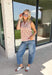 Add a touch of playful charm to your everyday wardrobe with this effortlessly polished sleeveless top from Entro. Featuring a soft ecru backdrop with a rust polka dot print and subtle pops of pink, this lightweight blouse is full of warm seasonal color. The flattering v-neckline keeps the look timeless, while the pleated back detail adds beautiful movement and an easy, flowy fit. 